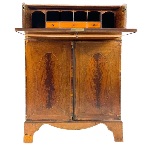 696 - A George III style mahogany secretaire. With oval figured and rosewood banded drop front, enclosing ... 