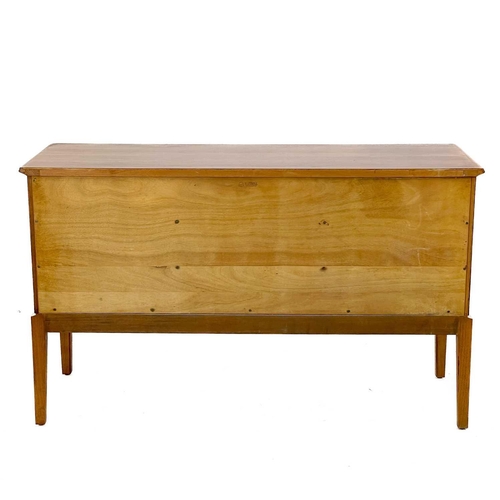 701 - A Gordon Russell Broadway walnut veneer sideboard. With three central drawers flanked by two cupboar... 