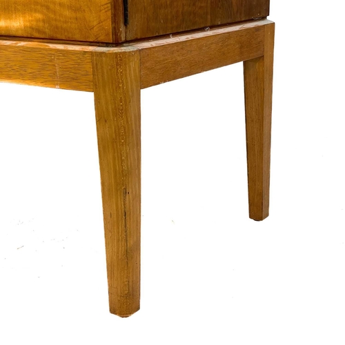 701 - A Gordon Russell Broadway walnut veneer sideboard. With three central drawers flanked by two cupboar... 