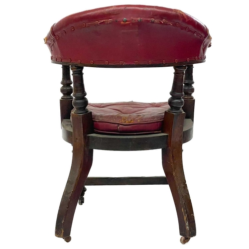 702 - A Victorian walnut bow back desk or armchair. With padded leather top rail and buttoned cushion, on ... 