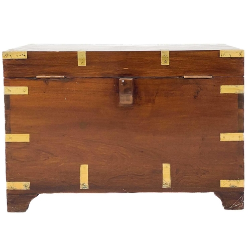 704 - A brass bound teak campaign style small chest. 20th century, with twin brass handles and bracket fee... 