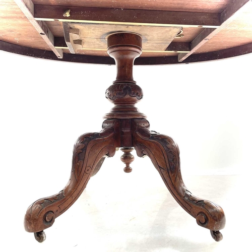 706 - A Victorian walnut inlaid loo table. The oval top with quarter veneer boxwood urn marquetry on turne... 