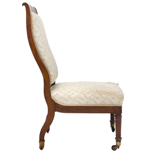 713 - A Victorian rosewood and inlaid nursing chair. With upholstered back and seat, raised on turned and ... 