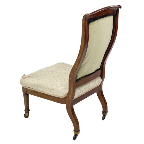 713 - A Victorian rosewood and inlaid nursing chair. With upholstered back and seat, raised on turned and ... 