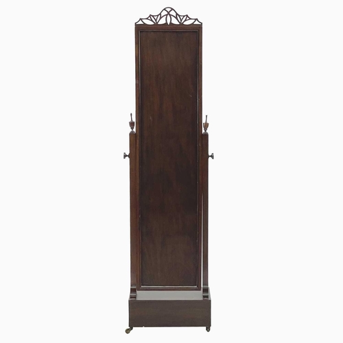 718 - A mahogany cheval mirror. With fretwork pierced pediment urn finials on reeded column supports above... 