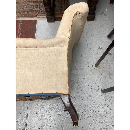 719 - A Victorian walnut low armchair. Raised on turned front legs, height 79cm, width 69cm, depth 77cm.