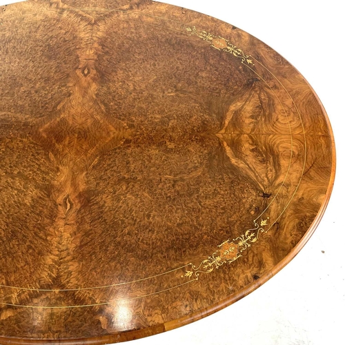 720 - A Victorian burr walnut oval loo table. With a quarter veneered top with boxwood stringing and inlay... 