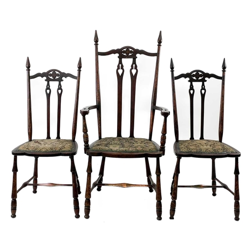 721 - A set of three mahogany Arts and Crafts chairs. Circa 1900, with pierced foliate and reverse spade m... 