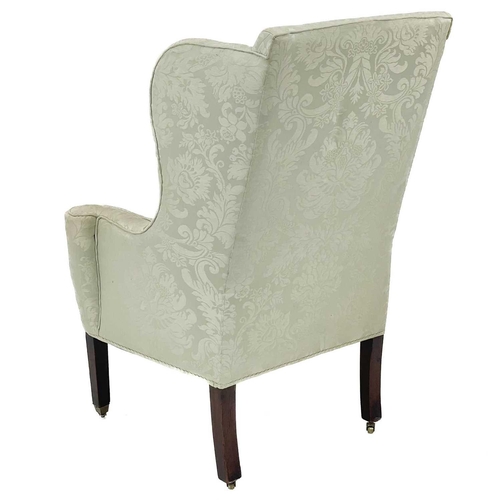 733 - A George III style mahogany framed wing armchair. With outscroll arms, and raised on square legs and... 