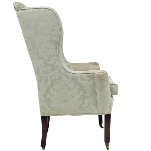 733 - A George III style mahogany framed wing armchair. With outscroll arms, and raised on square legs and... 