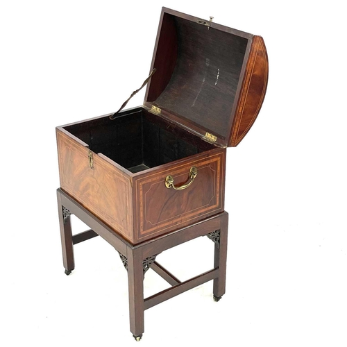 739 - A late George III mahogany cellarette on a stand. The domed top with satinwood crossbanding and boxw... 