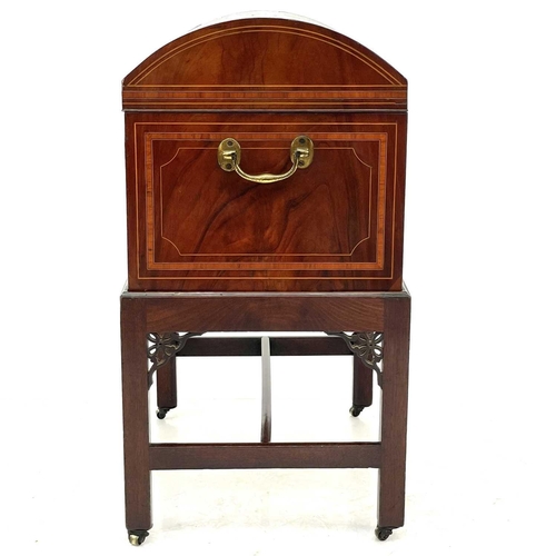 739 - A late George III mahogany cellarette on a stand. The domed top with satinwood crossbanding and boxw... 