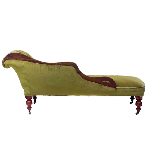 742 - A late Victorian beech frame chaise longue. With button back upholstery on turned supports and brass... 