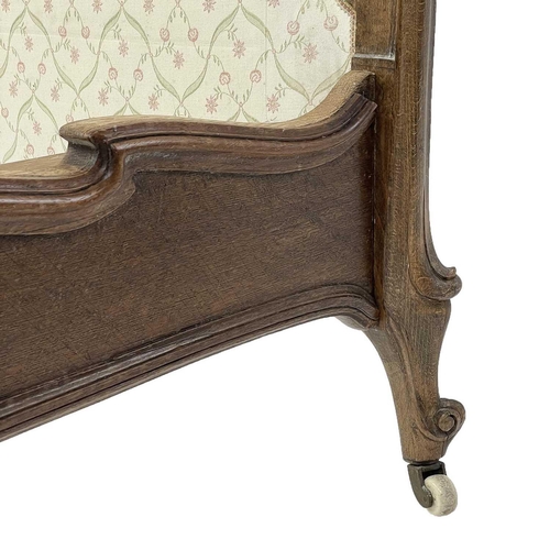 744 - A late 19th French walnut lit bateau. With ribbon, knot and bow carved detailing, on cabriole legs a... 