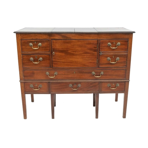 746 - A Regency mahogany Gentleman's washstand cabinet. With a hinged folding top above an arrangement of ... 