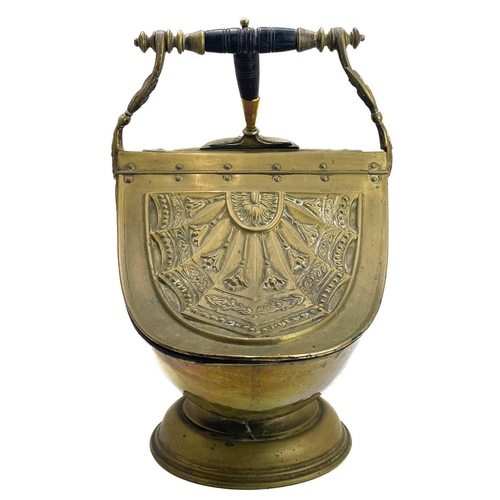 76 - A late Victorian Neo-Classical style brass coal scuttle. With lift-up lid and turned and ebonised ha... 