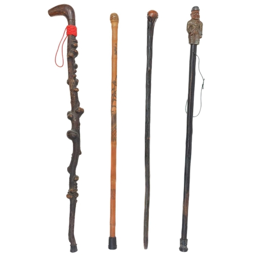 84 - A waking stick with a cast metal cold painted handle of a circa 1890 dressed gentleman. Together wit... 