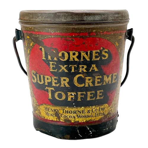 87 - A Thorne's toffee tin and cover and a copper gallon measure. The tin of bucket form promoting 'Extra... 