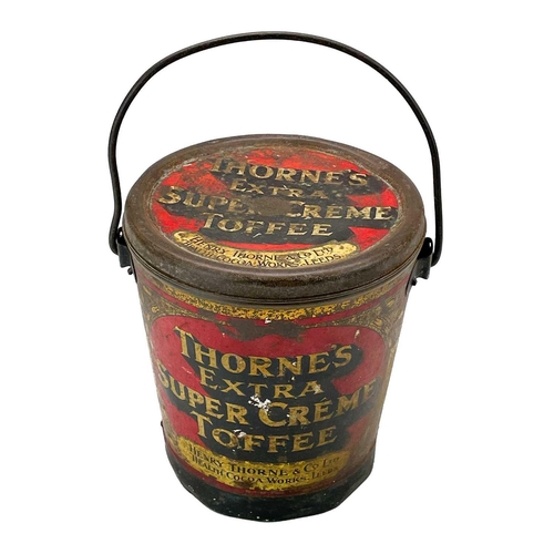 87 - A Thorne's toffee tin and cover and a copper gallon measure. The tin of bucket form promoting 'Extra... 