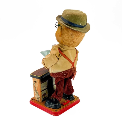 96 - A Japanese tinplate bartender figure. 'Charley Weaver', with battery operated movement, height 30cm,... 