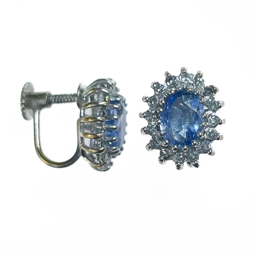 193 - A pair of 9ct white gold oval cornflower blue sapphire and diamond cluster screw back earrings. The ... 