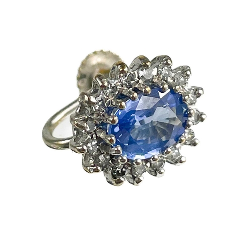 193 - A pair of 9ct white gold oval cornflower blue sapphire and diamond cluster screw back earrings. The ... 