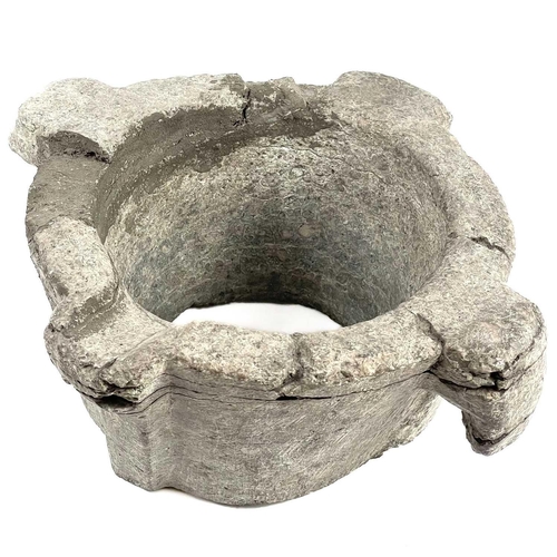 27 - A stone mortar. Possibly mediaeval, damaged, height 12cm