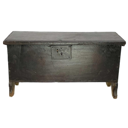 60 - A small oak coffer. Late 17th/early 18th century, with iron lock plate and raised on shaped end supp... 