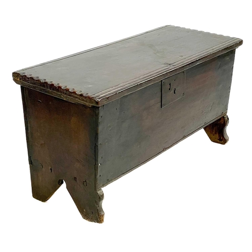60 - A small oak coffer. Late 17th/early 18th century, with iron lock plate and raised on shaped end supp... 