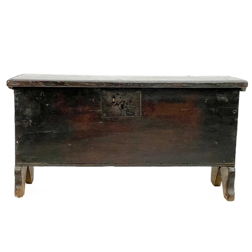 60 - A small oak coffer. Late 17th/early 18th century, with iron lock plate and raised on shaped end supp... 