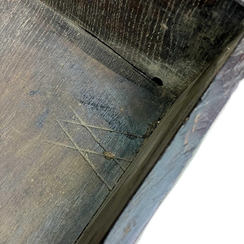 60 - A small oak coffer. Late 17th/early 18th century, with iron lock plate and raised on shaped end supp... 