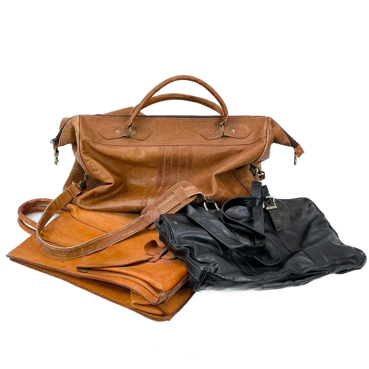 A brown leather holdall. Together with a leather tote bag an Enny