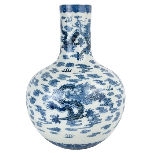 1000 - A Chinese porcelain dragon vase, 19th century. Decorated with a stylised dragons amongst clouds, hei... 