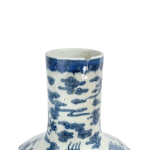 1000 - A Chinese porcelain dragon vase, 19th century. Decorated with a stylised dragons amongst clouds, hei... 