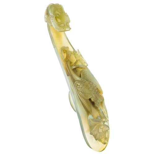 1004 - A Chinese agate belt hook, 18th century. The shaft carved with a bird amongst flowers, facing the dr... 