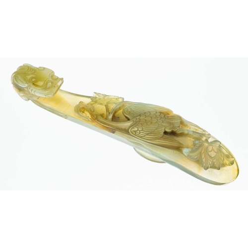 1004 - A Chinese agate belt hook, 18th century. The shaft carved with a bird amongst flowers, facing the dr... 