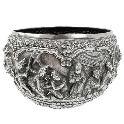 1016 - A Burmese silver bowl, circa 1900. Repousse decorated in high relief with figures and animals, heigh... 