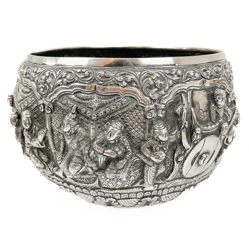 1016 - A Burmese silver bowl, circa 1900. Repousse decorated in high relief with figures and animals, heigh... 