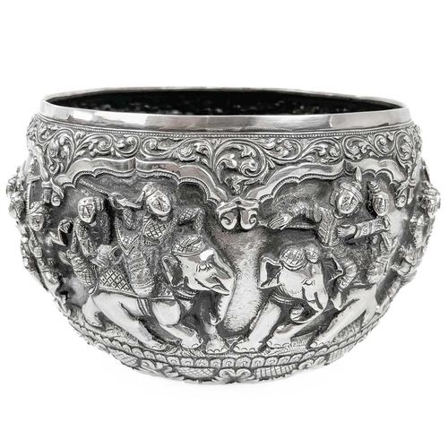 1016 - A Burmese silver bowl, circa 1900. Repousse decorated in high relief with figures and animals, heigh... 