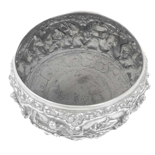 1016 - A Burmese silver bowl, circa 1900. Repousse decorated in high relief with figures and animals, heigh... 