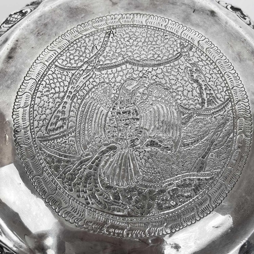 1016 - A Burmese silver bowl, circa 1900. Repousse decorated in high relief with figures and animals, heigh... 