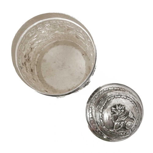 1017 - Two Burmese silver lidded cannisters, mid 20th century Repousse decorated witrh figures in landscape... 