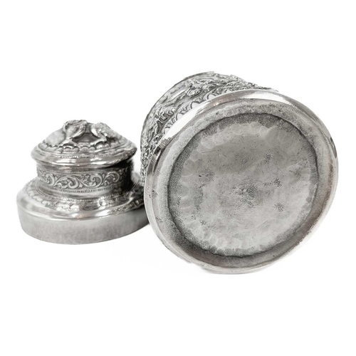 1017 - Two Burmese silver lidded cannisters, mid 20th century Repousse decorated witrh figures in landscape... 