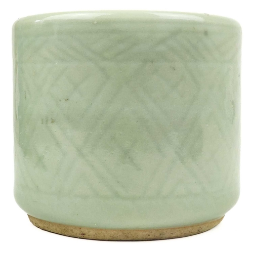 1018 - A Chinese celadon brush pot, 19th century. The body with geometric motifs, height 9cm, diameter 11cm... 