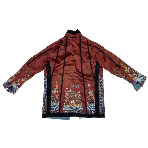 1023 - A Chinese silk embroidered jacket, early 20th century. The dragons with silk and metal thread, lengt... 