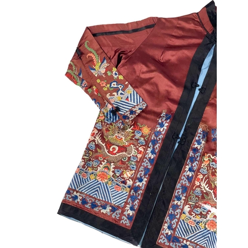 1023 - A Chinese silk embroidered jacket, early 20th century. The dragons with silk and metal thread, lengt... 