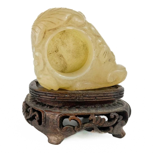 1056 - A Chinese mutton fat jade brush pot, 19th century Carved with foliage, on a carved hardwood stand, h... 