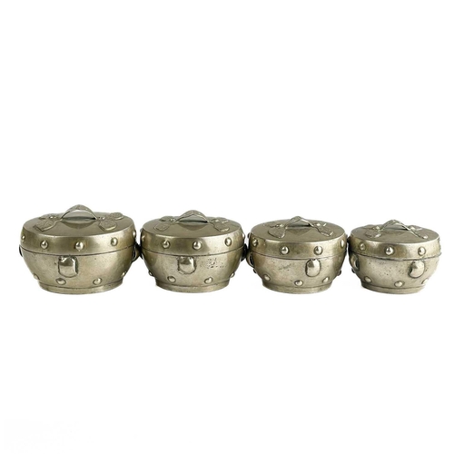 1072 - A Chinese silver set of four graduated circular boxes. The lids with loop strap handles, the boxes w... 