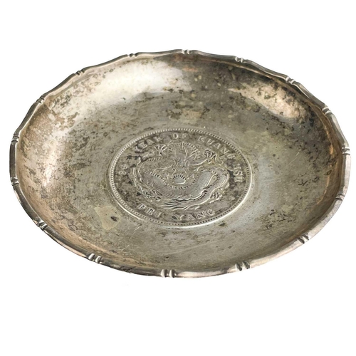 1073 - A Chinese silver dragon dollar Pei Yang coin inset dish, The dish with faux bamboo cast rim, the coi... 