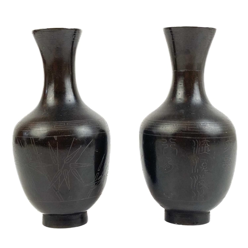 1076 - A pair of Chinese bronze vases, 19th century. With silver wire decoration of bamboo and character ma... 